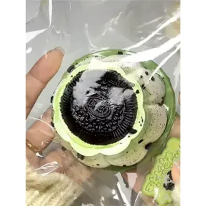 Kawaii matcha squishy held in hand with scalloped base