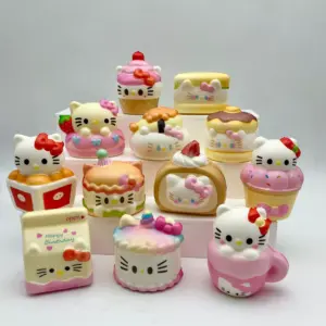 Small strawberry and chocolate-like brown topping details on cat-themed dessert figures
