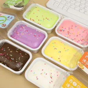 Close-up of a glossy pink squishy surface with a finger indentation and colorful sprinkles, inside a white tub with a transparent lid.