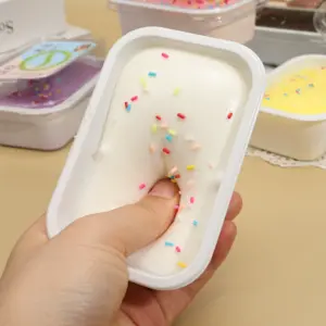 Assortment of ice cream cake squishy tubs in pastel and chocolate colors, each with a printed lid label and multicolor sprinkles.