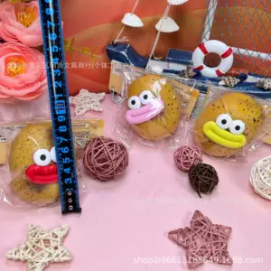 Close-up of tan-yellow potato squishy with dark speckles and googly eyes