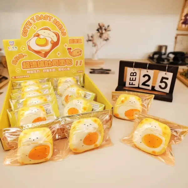 Yellow toast bread-shaped squishy toy with white center and orange egg yolk, showing cartoon face