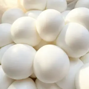 Close-up of uniform white spheres with specular highlights