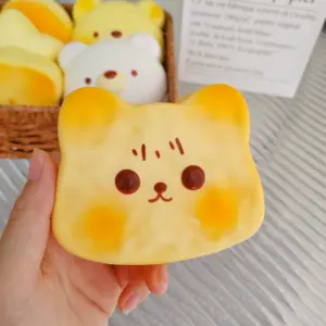 Hand holding a kawaii animal squishy toy over a woven basket